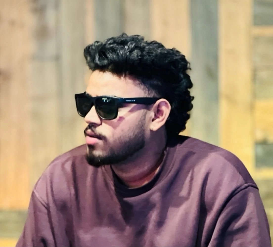 ALT Text: Best freelance digital marketing expert in Palakkad – professional portrait of a man wearing black sunglasses and a casual sweatshirt.